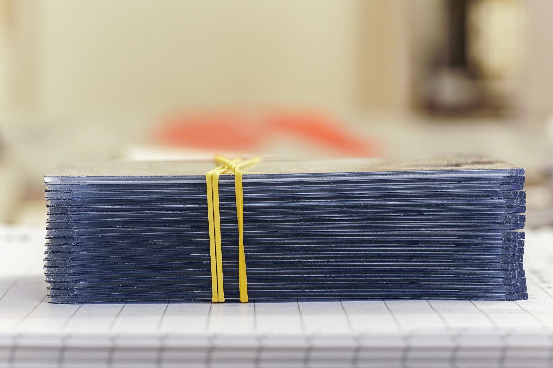 Stack of trading card sleeves and top loaders