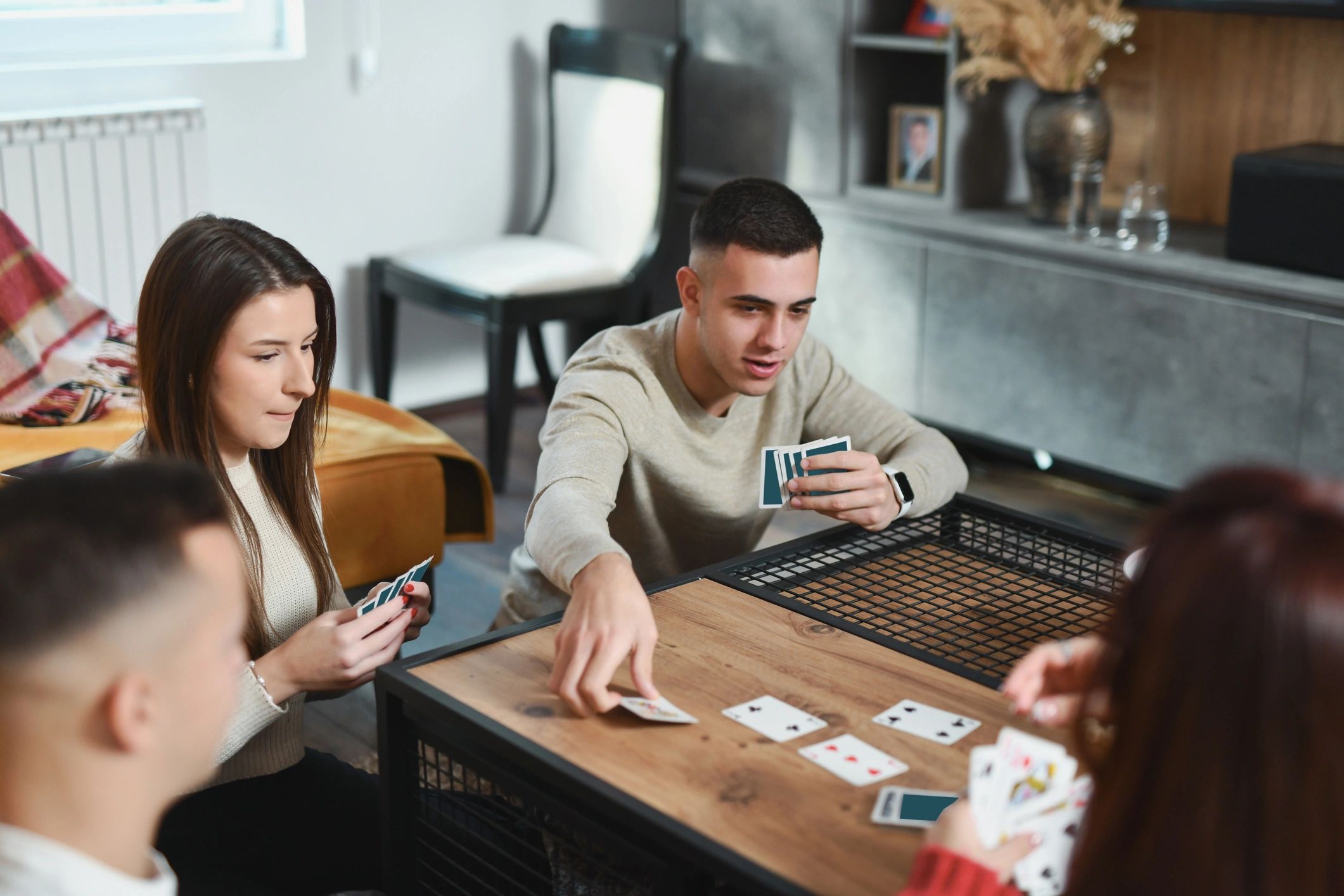 Player picking up cards from a table during a game